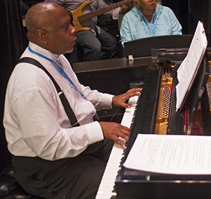 A black man playing piano.