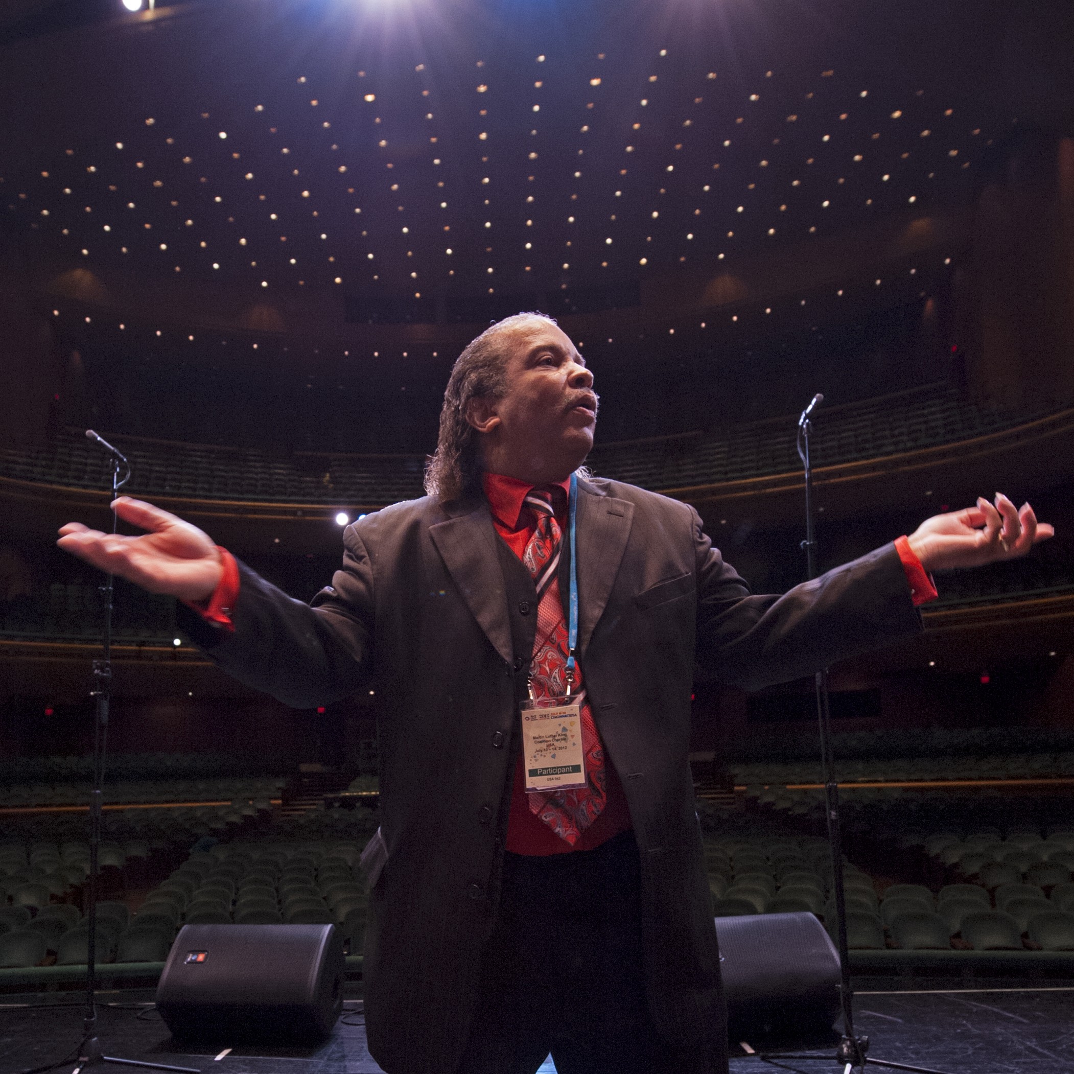 A black choir directory speaking to the choir.